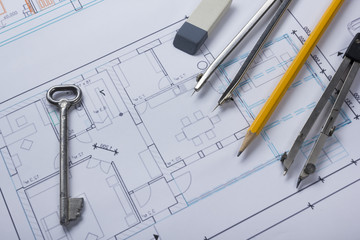 Architect worplace top view. Architectural project, blueprints, blueprint rolls and  divider compass, key, pencil card on plans. Construction background. Engineering tools. Copy space