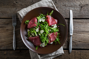 Delicious salad with arugula, cheese and dried beef