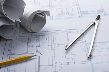 Architect worplace top view. Architectural project, blueprints, blueprint rolls and  divider compass, pencil on plans. Construction background. Engineering tools. Copy space