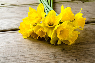 Yellow daffodils on wooden table