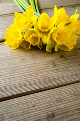 Yellow daffodils on wooden table