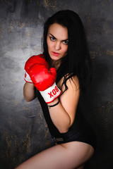 sexy young brunette model posing in boxing gloves