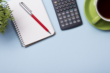 Office table with supply and coffe cup. View from above. Copy space for text