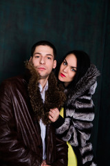 Young attractive couple. Handsome man and sexy woman in fur coat