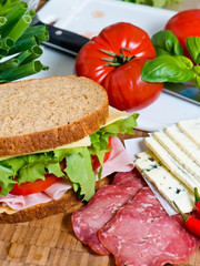 Fototapeta na wymiar Sandwich with lettuce, tomato, ham and cheese