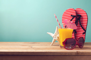Summer holiday vacation background with orange juice and flip flops
