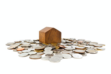 House on a heap of coins isolated on a white background. Saving money for buy home concept or build a house. Money coins for loan home. Coin stack thai baht. Close up.