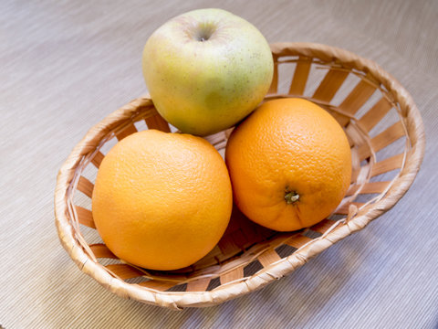 fruit basket on wooden background