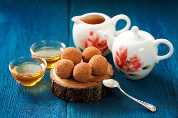 Homemade chocolate sweets and green tea brewed in china teapot o