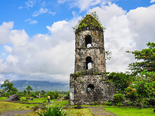 Fototapeta na wymiar Only the bell tower remains of the Cagsawa Church, which was buried by the 1814 eruption of Mayon Volcano in the municipality of Daraga, Albay, the Philippines.
