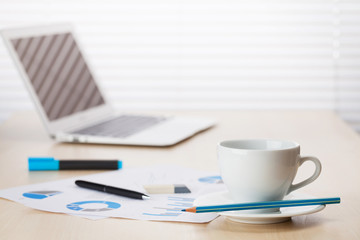 Office desk workplace with laptop and coffee