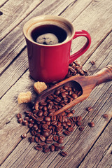 Coffee cup and beans on wooden table