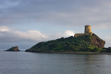 Fototapeta premium Tower Coltellazzo of Saint Efisio lighthouse at Nora archeological site, gulf of Cagliari, Sardinia, Italy