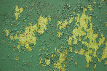 Green and yellow cracked paint on metal texture