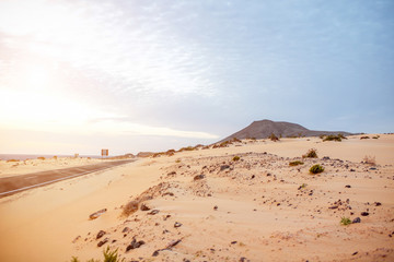 Desert road on Corralejo dunes on Fuerteventura island in Spain