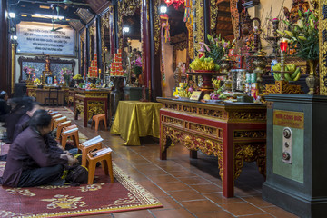 Women praying inside the Tran Quoc Pagoda, Hanoi, Vietnam