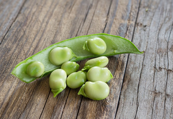 broad beans on wooden table