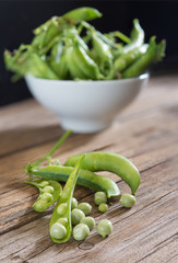 fresh peas on wooden table