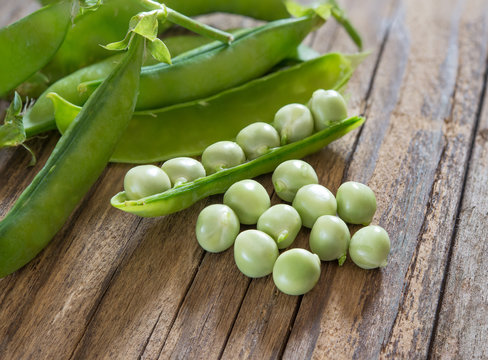 fresh peas on wooden table