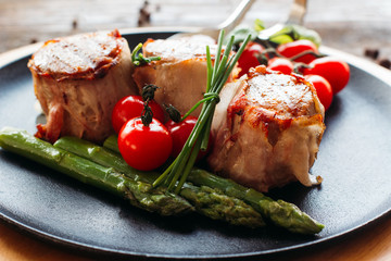 Meaty holiday dinner on a wooden table. Tasty holiday meat with fresh vegetables. Dinner in restaurant of mediterranean cuisine 