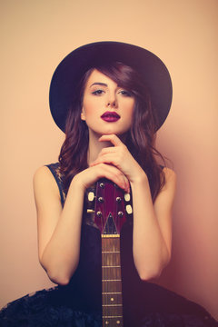 portrait of a young beautiful woman with guitar