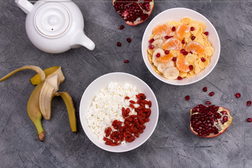 Healthy breakfast - corn flakes, goji, cottage cheese, milk and fruit. 