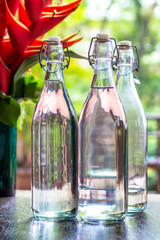 glass of bottles water on natural background.