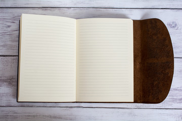 Classic Leather Bound Journal Book Fully Open on a White Barn Board Floor