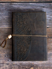 Classic Leather Bound Journal Book on a Old Barn Board Floor Straight On