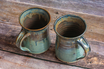 Two Rustic Clay Mugs on a Old Barn Board Floor