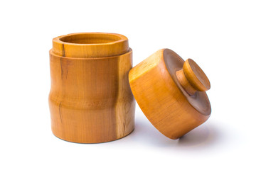 Wooden jar with lid off leaning on its side