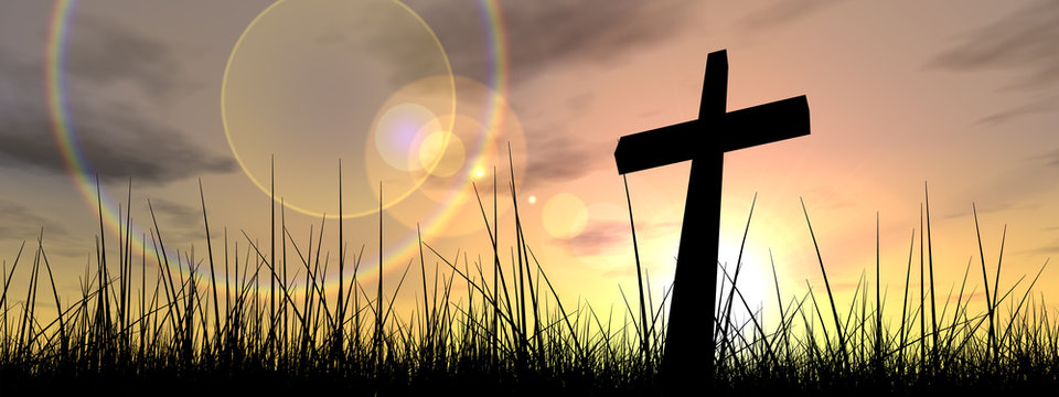 Conceptual cross or religion silhouette in grass at sunset banner