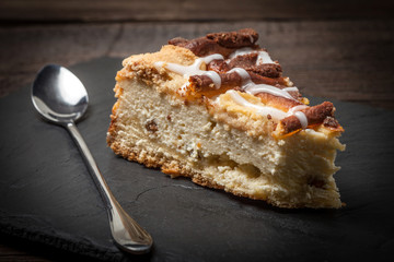 Cheesecake with raisins on a slate plate.