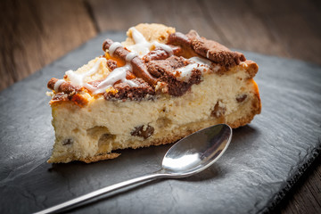Cheesecake with raisins on a slate plate.