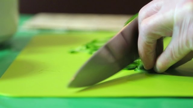Sushi master slices of avocado.