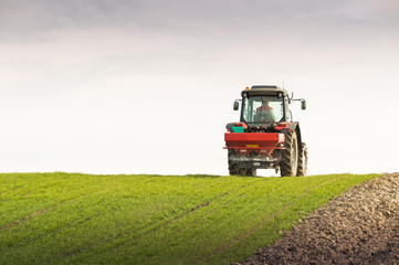 Fototapeta premium tractor fertilizing in field