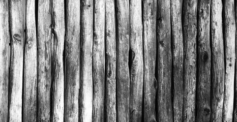 Palisade stockade palings logs. Abstract background, old, ancient. Black and white image.