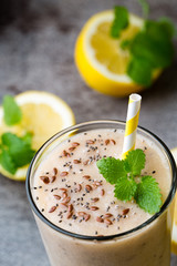 Banana and lemon smoothie, on the grey  background.