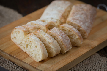 bread sliced and whole on a wooden board