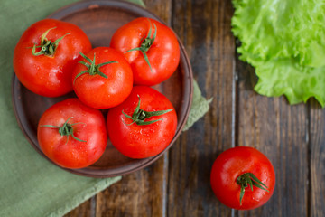 juicy and beautiful tomatoes on wooden rustic background