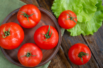 juicy and beautiful tomatoes on wooden rustic background