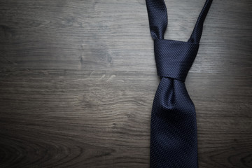 Male necktie on dark textured background