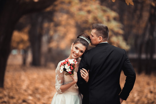 Luxury married wedding couple, bride and groom posing in park autumn