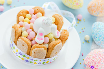 Happy Easter bunny and colorful sweets for children on the holid