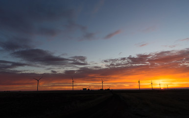 Fototapeta na wymiar Bright Orange Sunrise Signal Peak Wind Turbines Washington Green