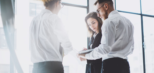 Business team work process. Photo young professionals crew working with new startup project. Project managers meeting. Analyze business plans laptop. Blurred background, film effect. Wide mockup