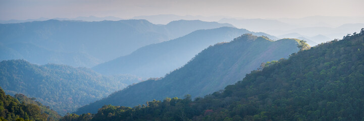 Blue mountains panorama - Cardamom Hills in the haze on the road Alleppey-Kumily, Kerala, India - panoramic 1x3 banner size photo