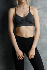 Obraz premium Beautiful fit, sexy female body on grey background