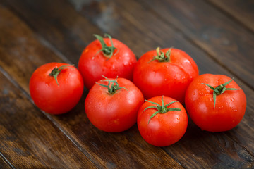 juicy and beautiful tomatoes on wooden rustic background