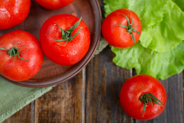 juicy and beautiful tomatoes on wooden rustic background